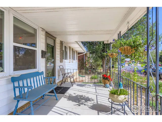 a view of a house with a porch and furniture