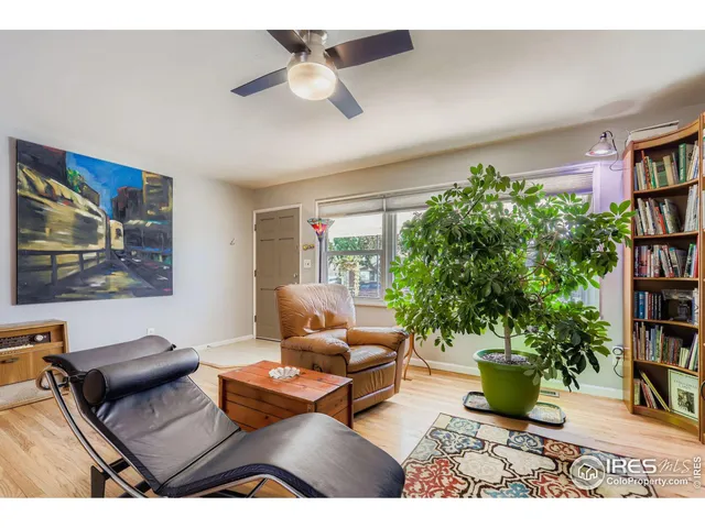 a living room with furniture and a book shelf