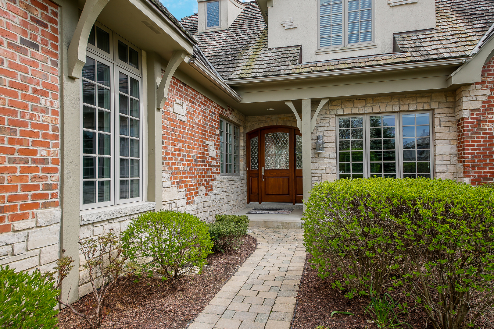 59 Forest Gate Circle Oak Brook, IL 60523 - Photo 2 of 30 a front view of a house with a garden