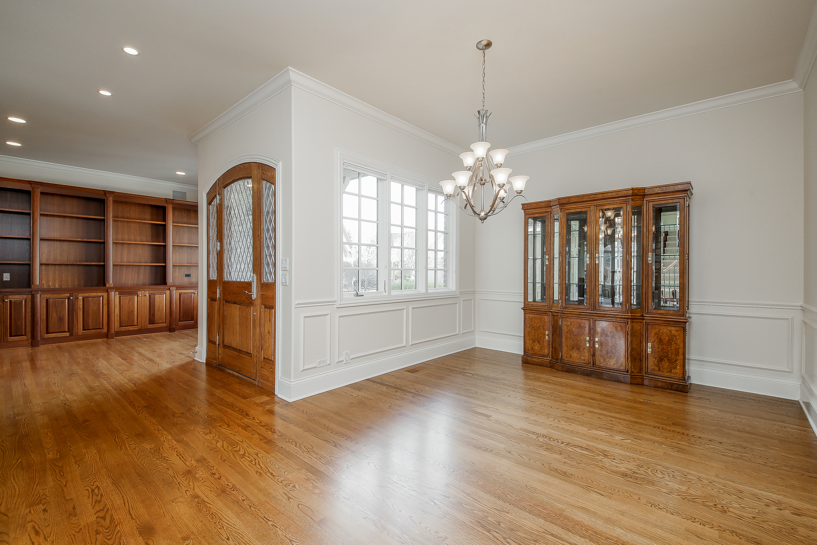 59 Forest Gate Circle Oak Brook, IL 60523 - Photo 5 of 30 a view of an empty room with window and wooden floor