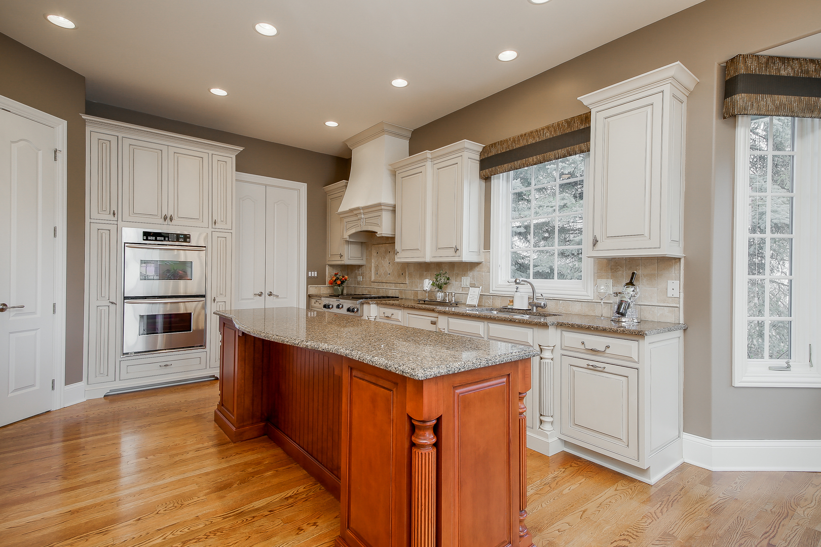 59 Forest Gate Circle Oak Brook, IL 60523 - Photo 10 of 30 a kitchen with stainless steel appliances granite countertop a sink stove and refrigerator