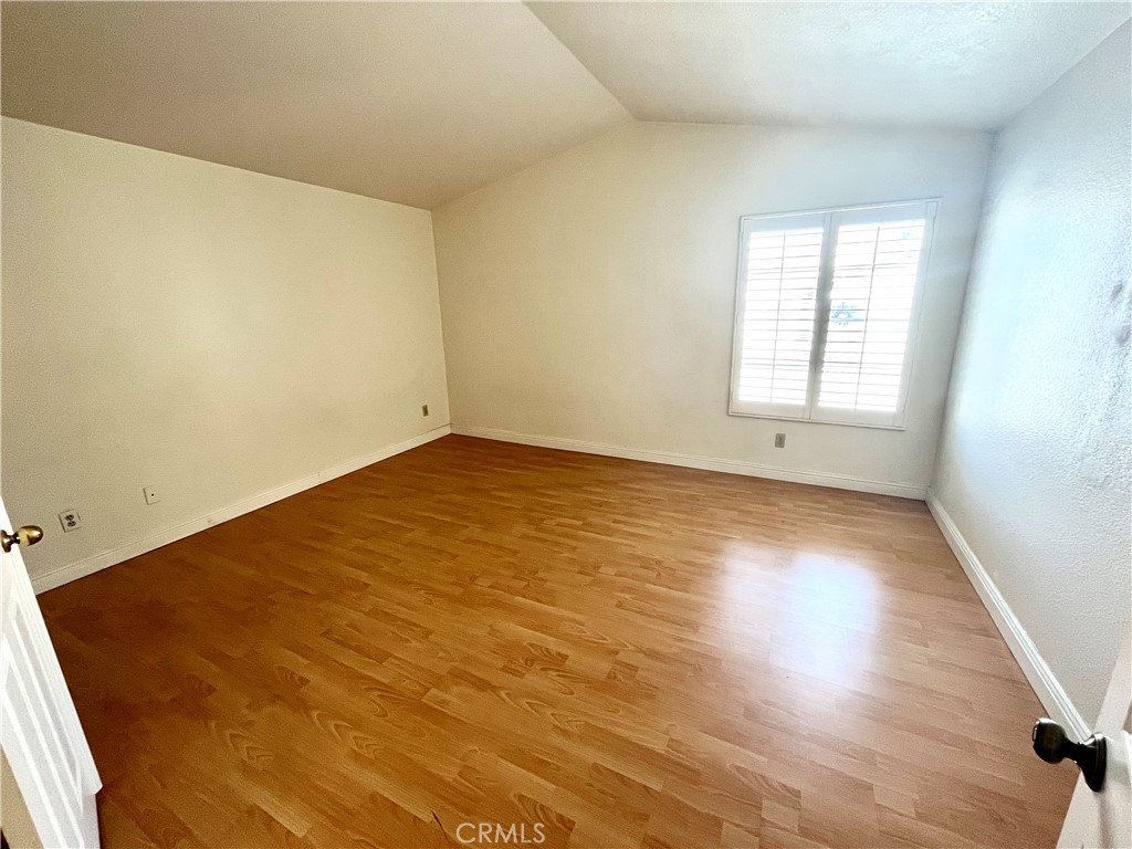 7619 Haven Avenue, Unit B Rancho Cucamonga, CA 91730 - Photo 11 of 16 an empty room with wooden floor and windows
