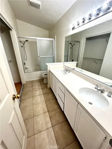 a bathroom with a double vanity sink mirror and shower