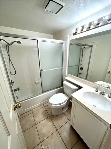 a bathroom with a toilet sink and shower