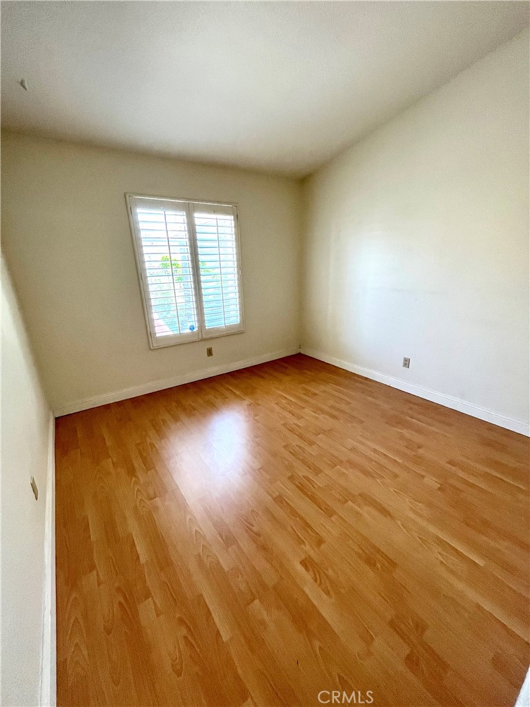 7619 Haven Avenue, Unit B Rancho Cucamonga, CA 91730 - Photo 10 of 16 an empty room with wooden floor and windows