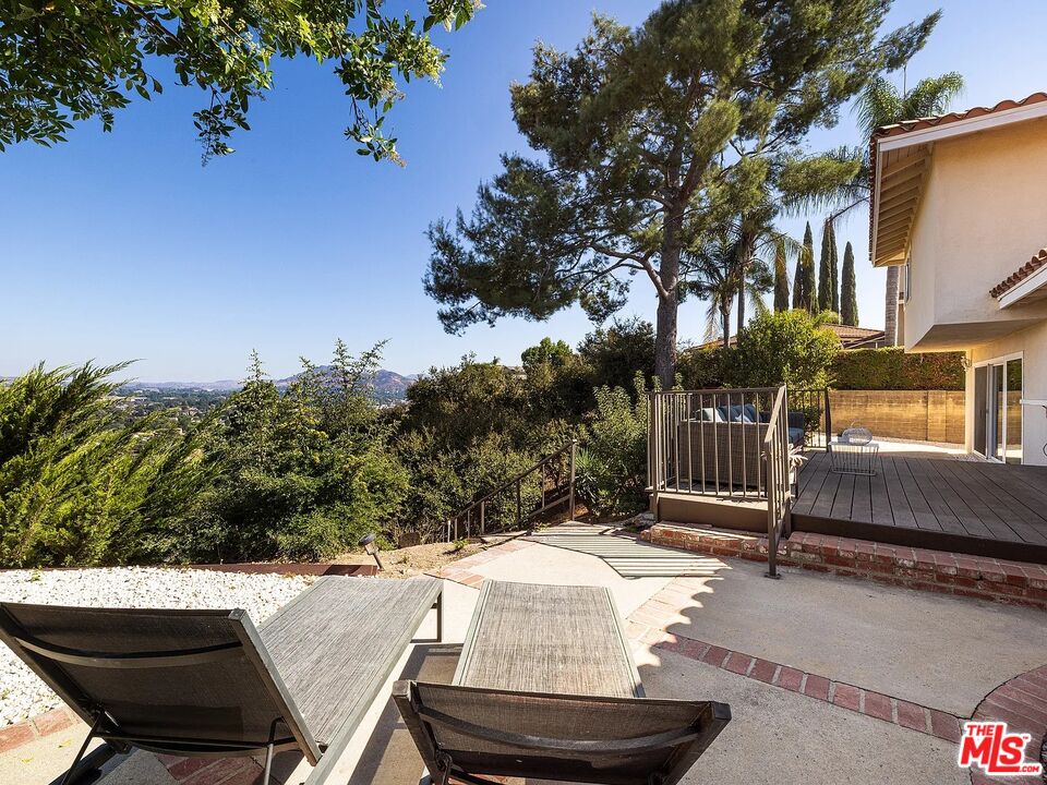 1096 Stoneshead Court Westlake Village, CA 91361 - Photo 15 of 38 a view of patio with table and chairs and potted plants with wooden fence