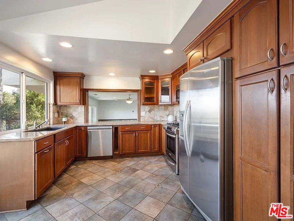 1096 Stoneshead Court Westlake Village, CA 91361 - Photo 18 of 38 a large kitchen with stainless steel appliances granite countertop a refrigerator and a sink