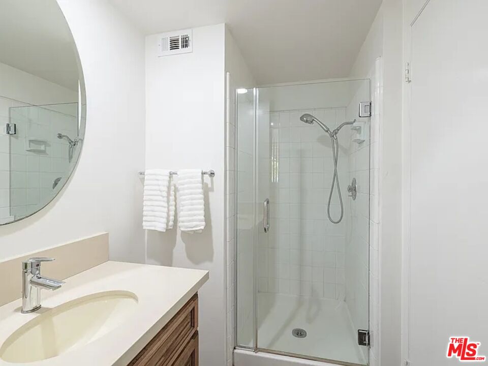 1096 Stoneshead Court Westlake Village, CA 91361 - Photo 25 of 38 a bathroom with a sink vanity granite shower and a mirror
