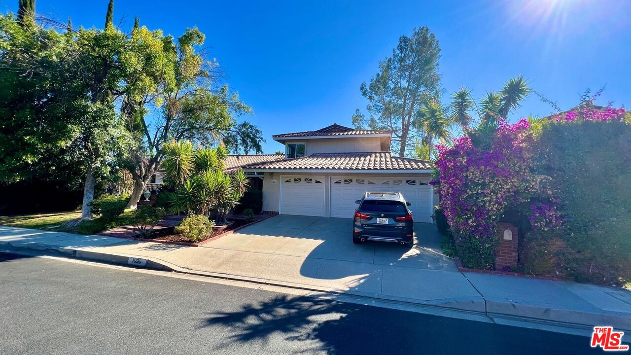 1096 Stoneshead Court Westlake Village, CA 91361 - Photo 35 of 38 a car parked in front of the house