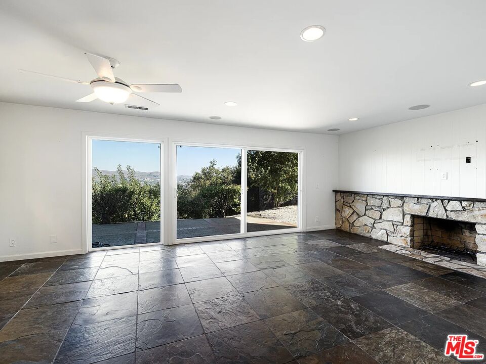 1096 Stoneshead Court Westlake Village, CA 91361 - Photo 8 of 38 a view of an empty room with a window and fireplace