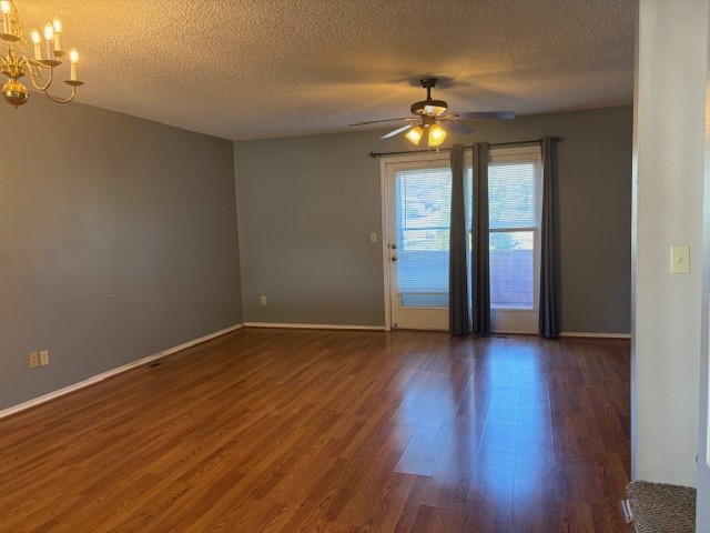 1800 Capps Road, Unit 9 Harrison, AR 72601 - Photo 10 of 18 Spare room with dark wood-style floors, a chandelier, a textured ceiling, and a ceiling fan