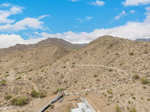 a view of a dry yard with mountains in back