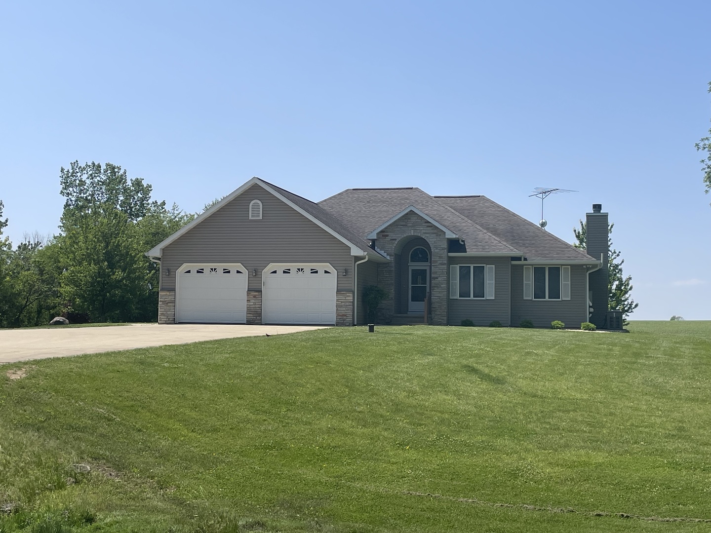 22109 Buell Road Sterling, IL 61081 - Photo 1 of 3 a front view of a house with yard and large trees