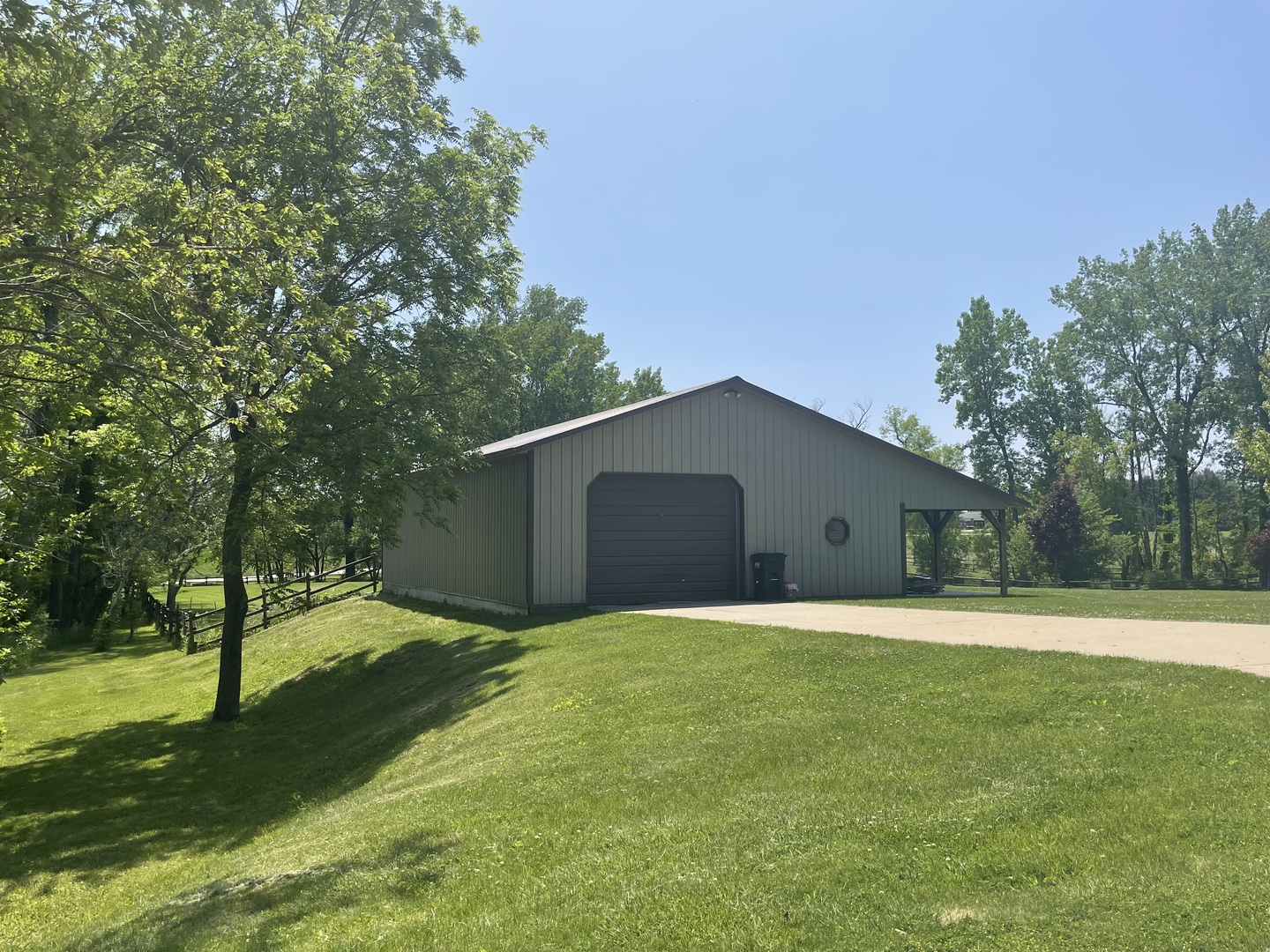22109 Buell Road Sterling, IL 61081 - Photo 2 of 3 a white house with a big yard and large trees