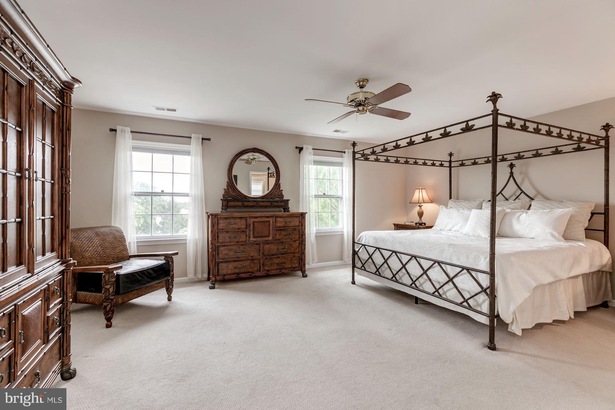 8745 Hickory Bend Trail Potomac, MD 20854 - Photo 14 of 30 a bedroom with a bed window and a chandelier