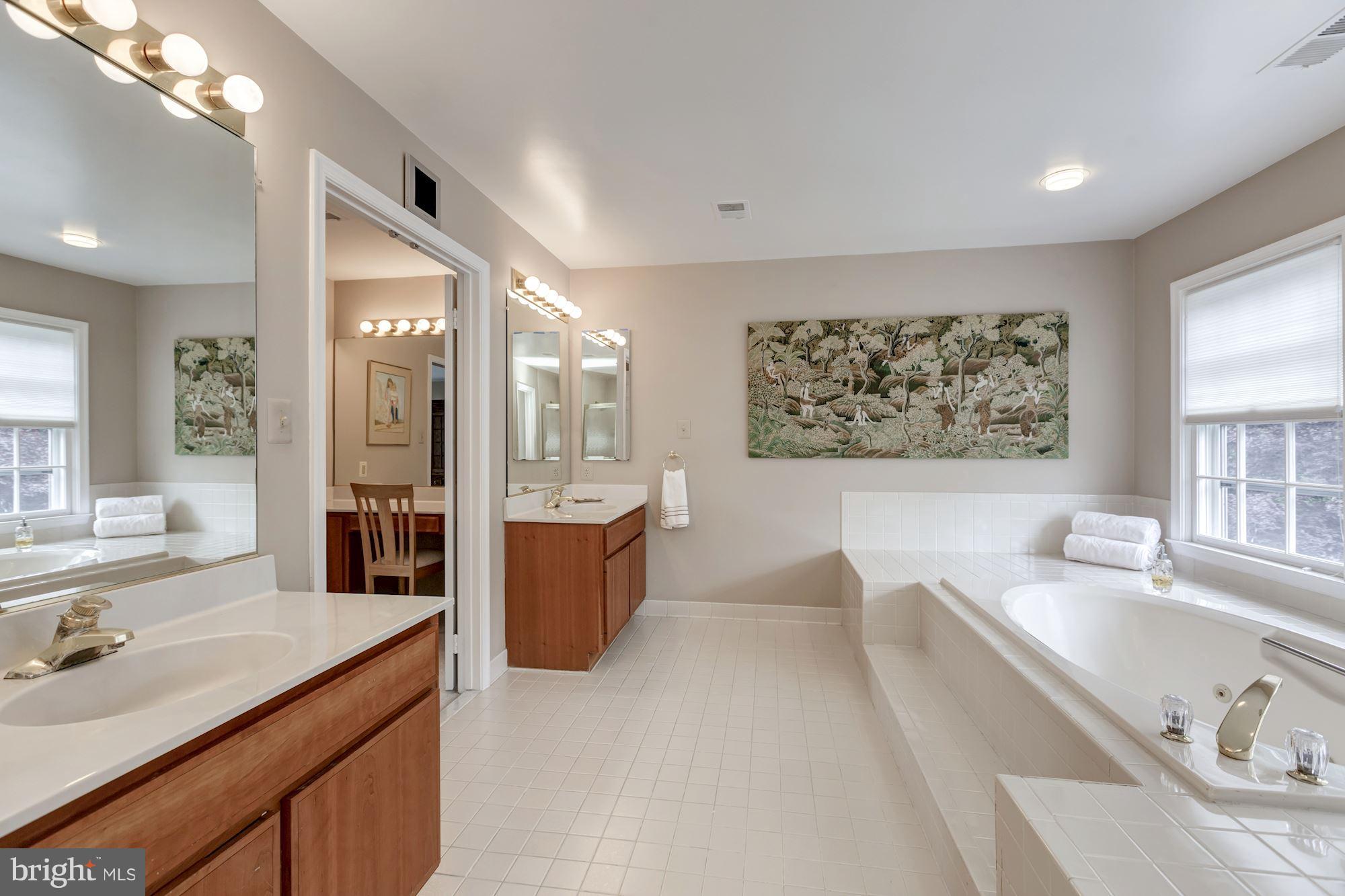 8745 Hickory Bend Trail Potomac, MD 20854 - Photo 16 of 30 a large bathroom with a tub a sink double vanity and window
