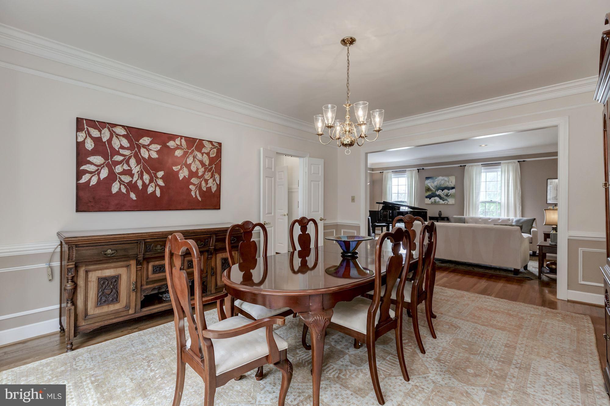8745 Hickory Bend Trail Potomac, MD 20854 - Photo 6 of 30 a view of a dining room with furniture and chandelier