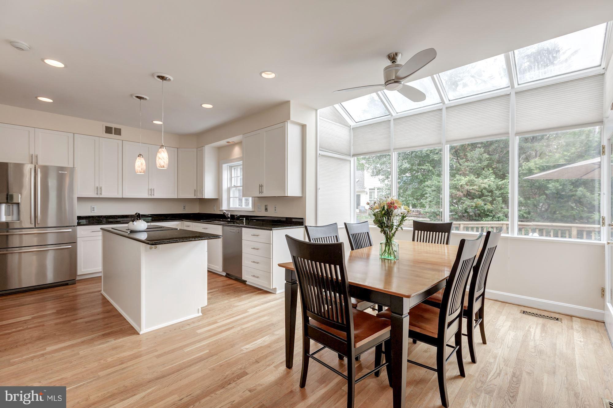 8745 Hickory Bend Trail Potomac, MD 20854 - Photo 8 of 30 a large kitchen with a table and chairs
