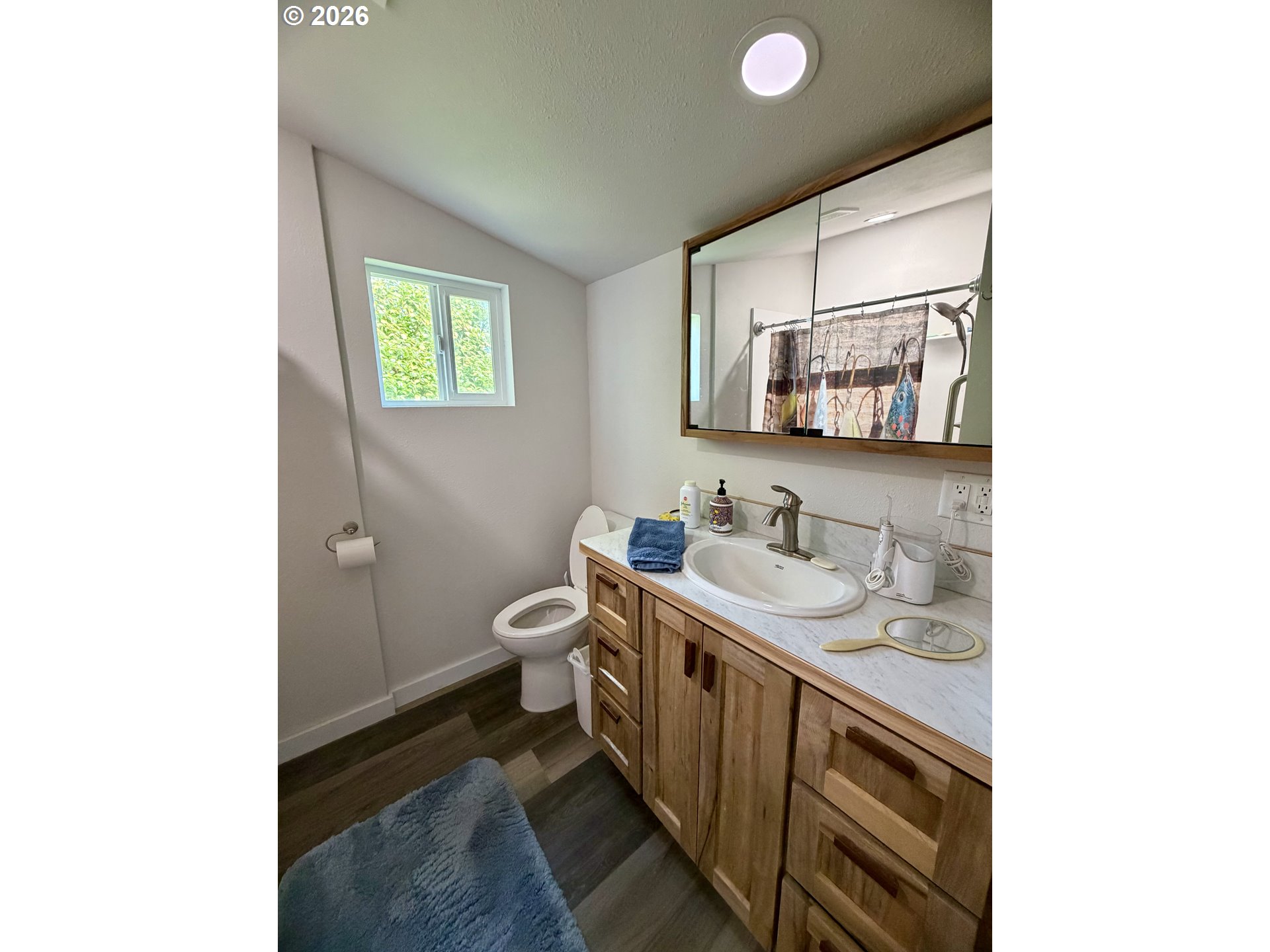 974 Fir Avenue Reedsport, OR 97467 - Photo 20 of 25 a bathroom with a toilet sink and mirror