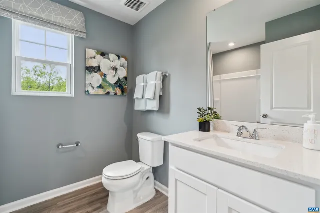 a en suite bathroom with a sink mirror and shower