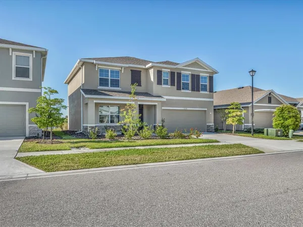 a front view of house with outdoor space and trees around