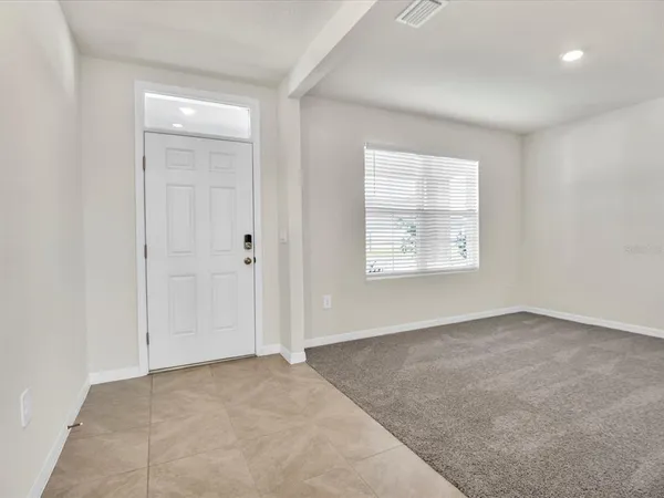 an empty room with windows and closet