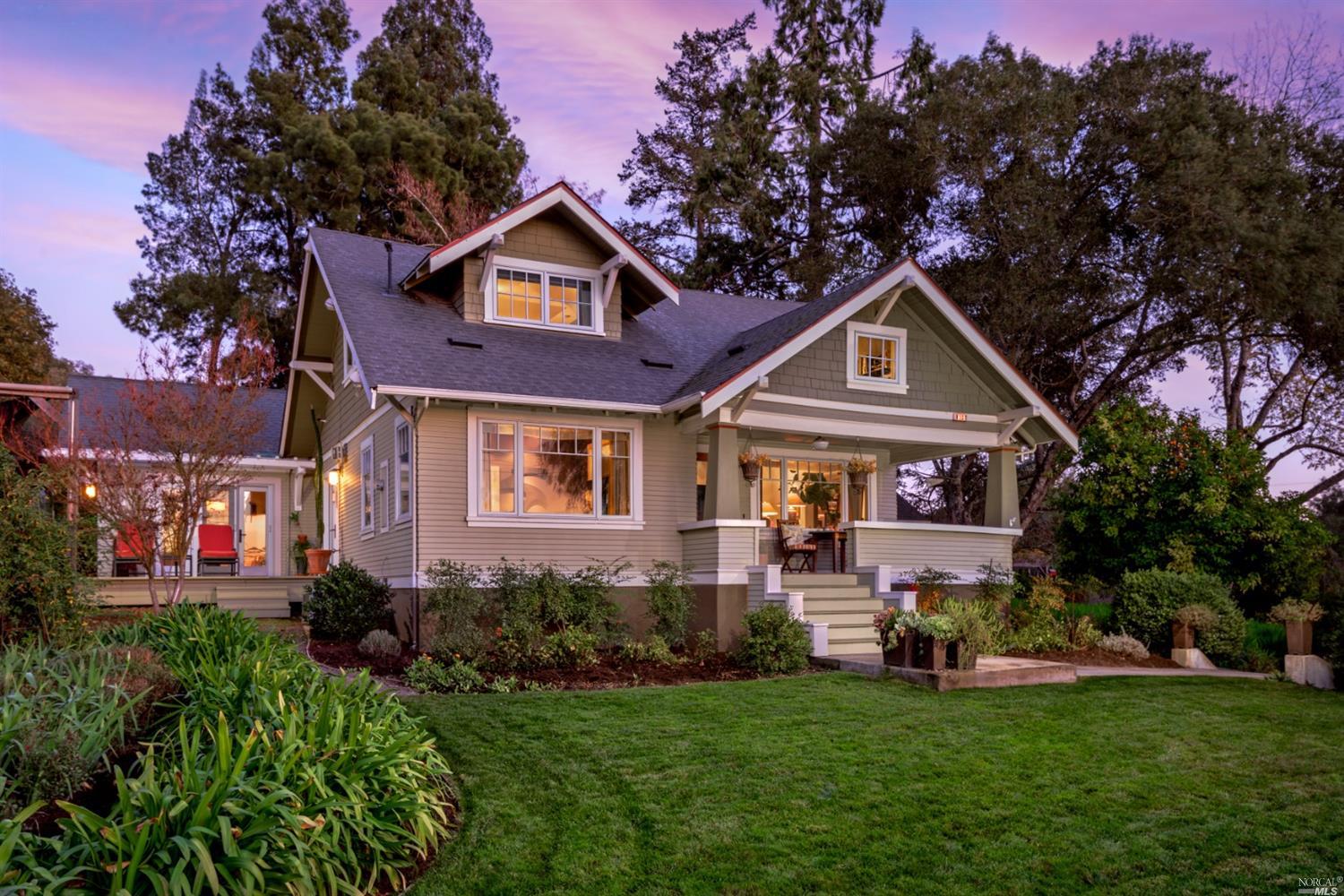 a front view of a house with a garden and plants