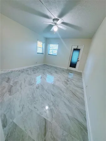 a white toilet sitting next to a bath tub and a shower