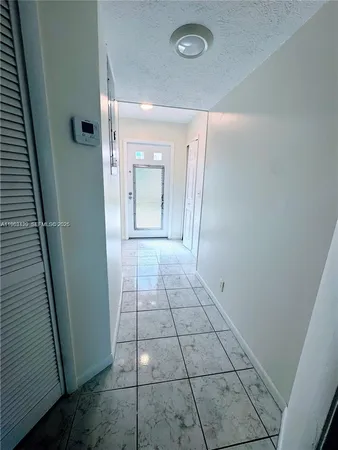a white toilet sitting next to a bathroom sink and a mirror