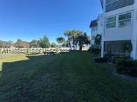 a view of a park with large trees