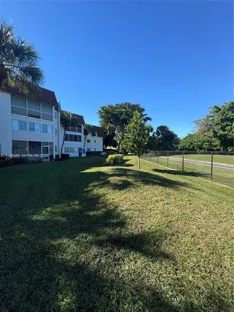 a view of a patio with table and chairs with wooden floor and fence