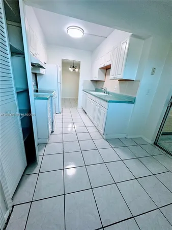 a room with washing machine and cabinets