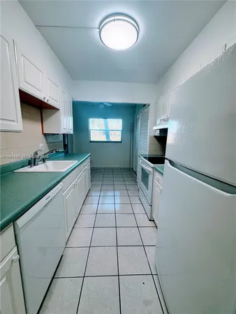 a kitchen with stainless steel appliances granite countertop a sink and a stove
