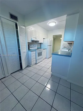 a kitchen with stainless steel appliances a sink and cabinets