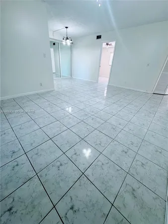 an empty room with white walls and a shower