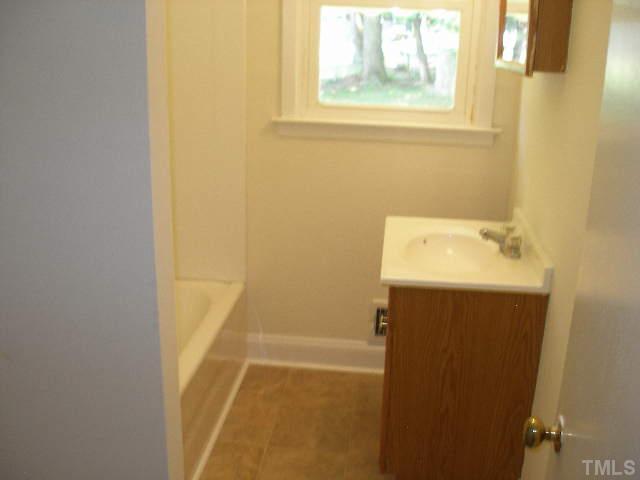 1218 Southerlund Road Garner, NC 27529 - Photo 9 of 10 a bathroom with a sink and a shower