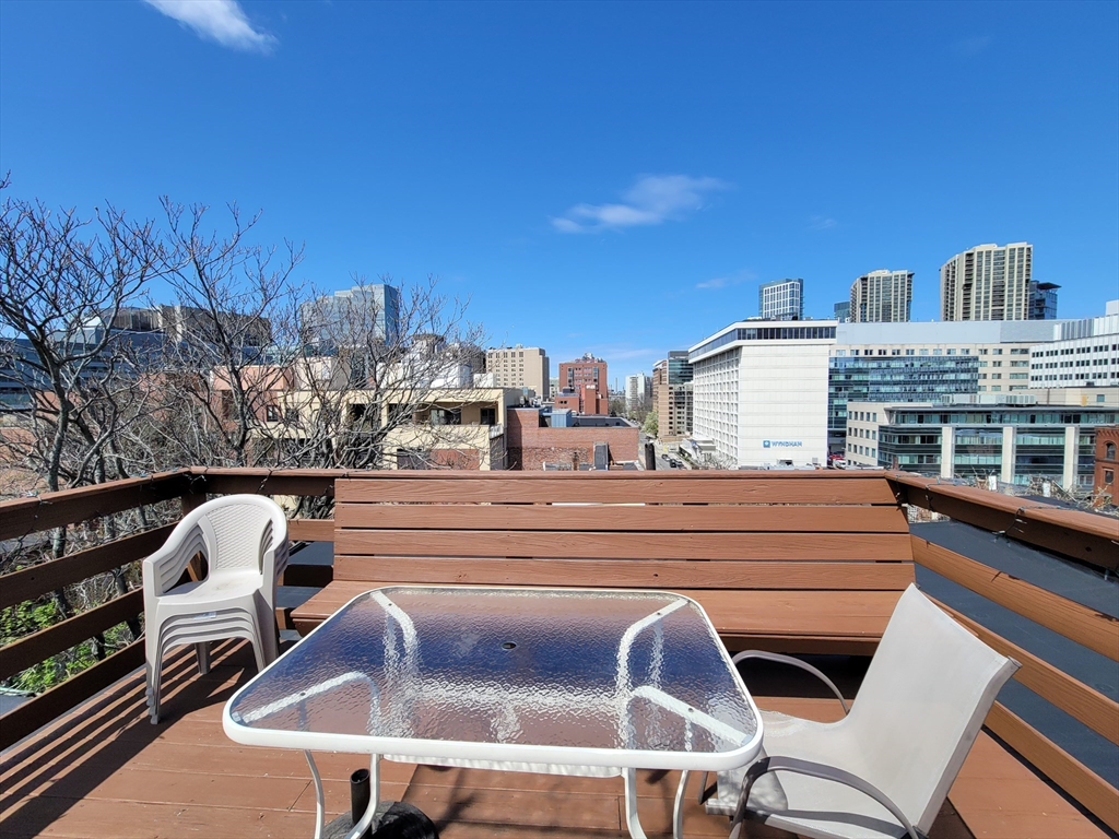 11 Phillips Street, Unit 8 Boston, MA 02114 - Photo 10 of 14 a view of roof deck with chairs and wooden fence