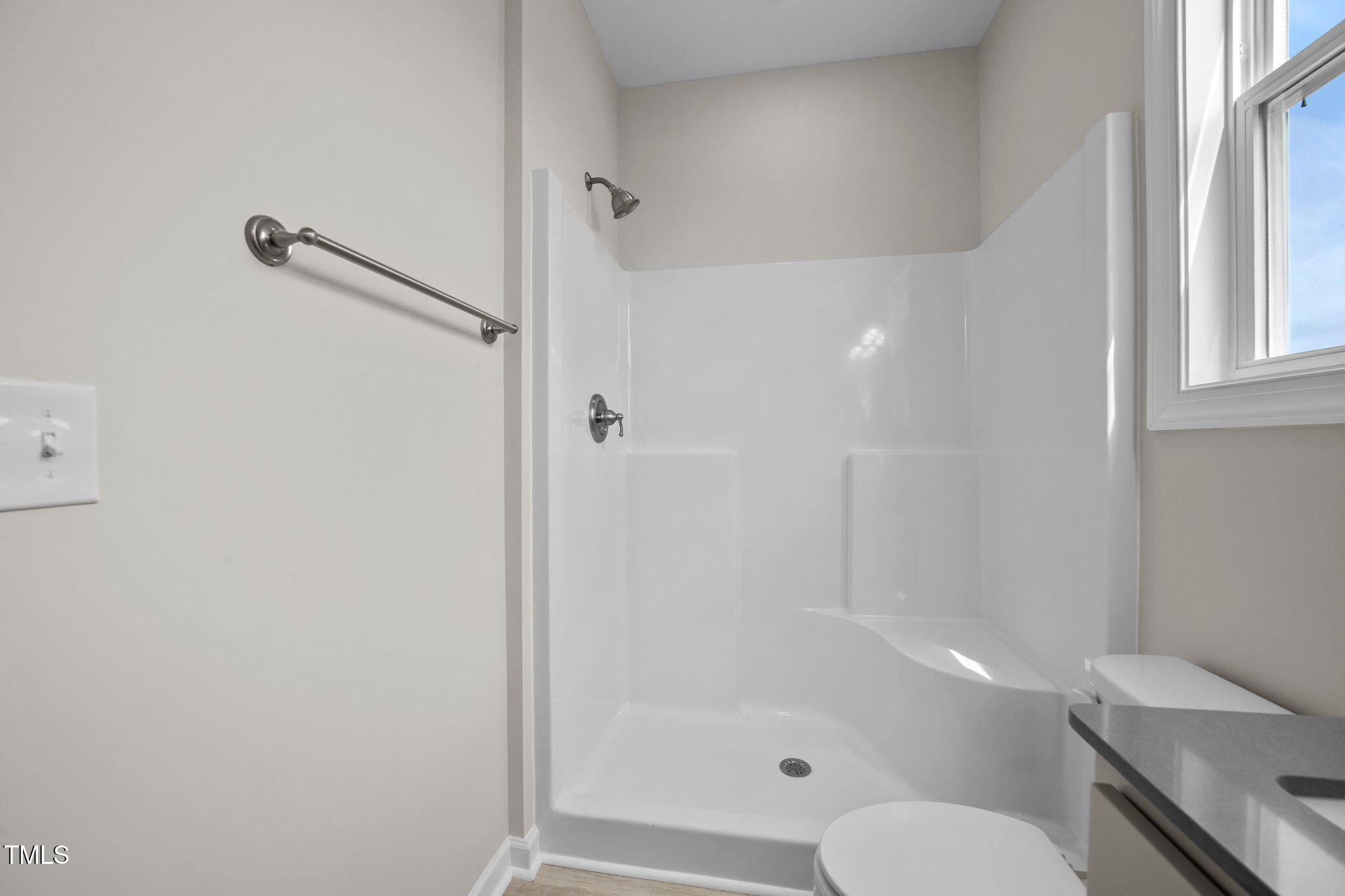 140 Brookhaven Drive Spring Hope, NC 27882 - Photo 17 of 32 a bathroom with a granite countertop toilet and a shower