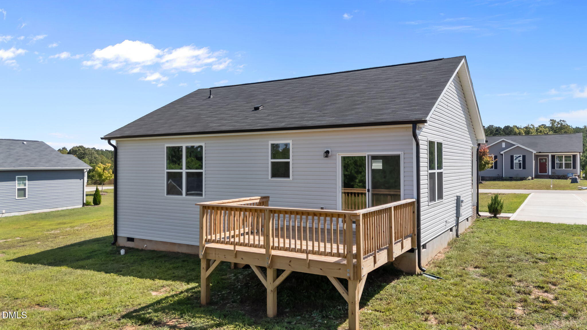 140 Brookhaven Drive Spring Hope, NC 27882 - Photo 27 of 32 a view of a house with a wooden deck and a yard
