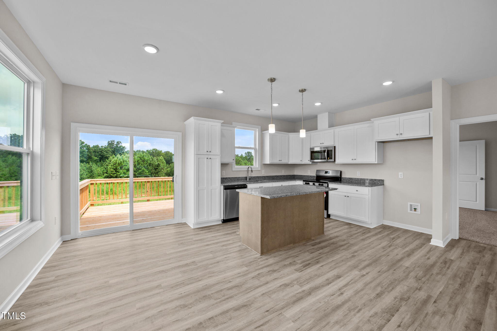 140 Brookhaven Drive Spring Hope, NC 27882 - Photo 10 of 32 a kitchen with a refrigerator sink and wooden cabinets