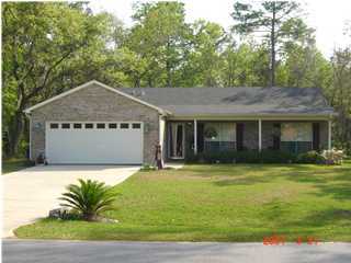 643 Bay Grove Road Freeport, FL 32439 - Photo 1 of 1 a front view of a house with a garden and yard