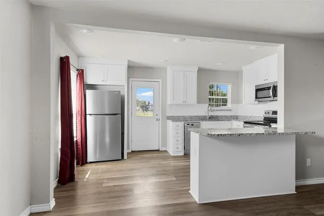 a kitchen with a refrigerator and a sink