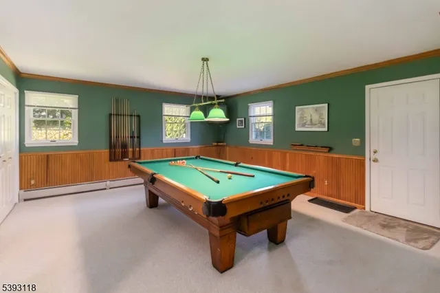 a room with pool table and windows
