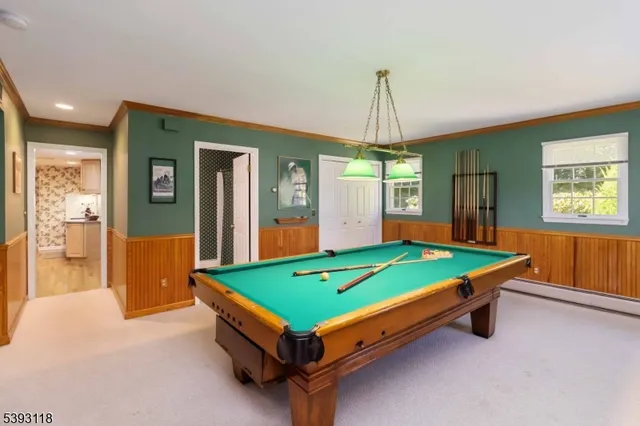 a room with pool table and windows
