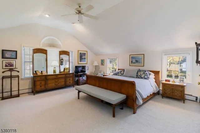 a spacious bedroom with a bed and ceiling fan