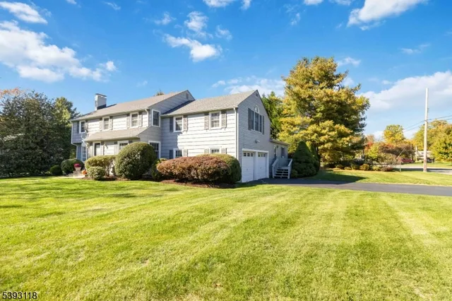 a house view with swimming pool in front of it