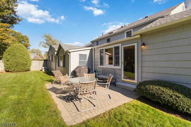 a view of a patio with table and chairs and potted plants