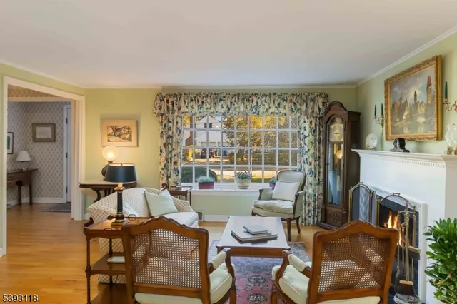 a living room with furniture a flat screen tv and a floor to ceiling window