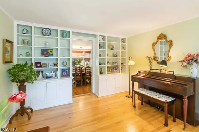 a living room with furniture and a piano