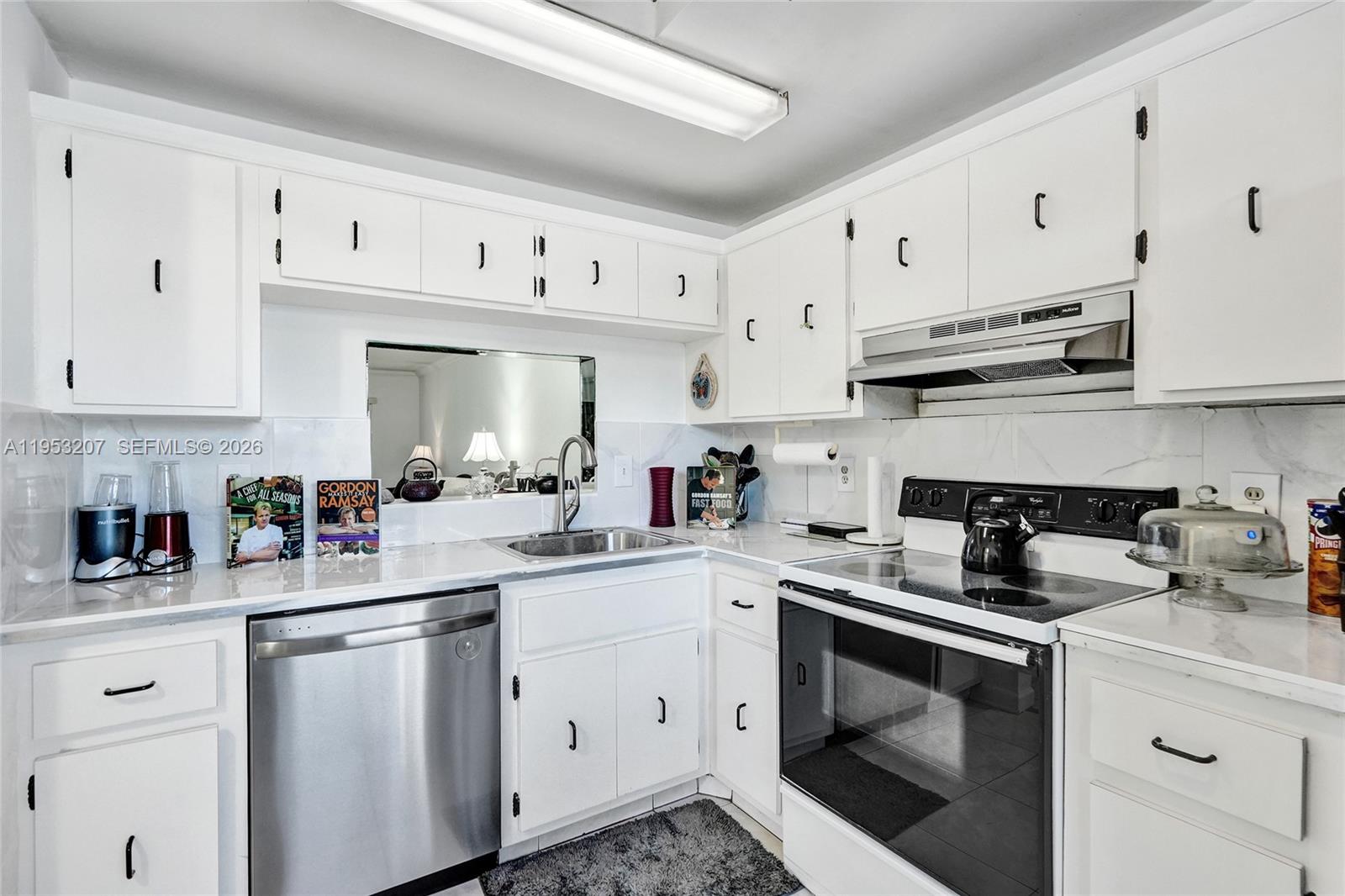 3511 Inverrary Drive, Unit 107 Lauderhill, FL 33319 - Photo 11 of 47 a kitchen with cabinets stainless steel appliances and a sink